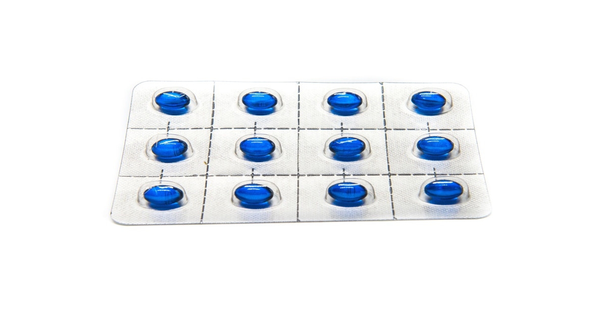 A blue capsules strip on a white background.