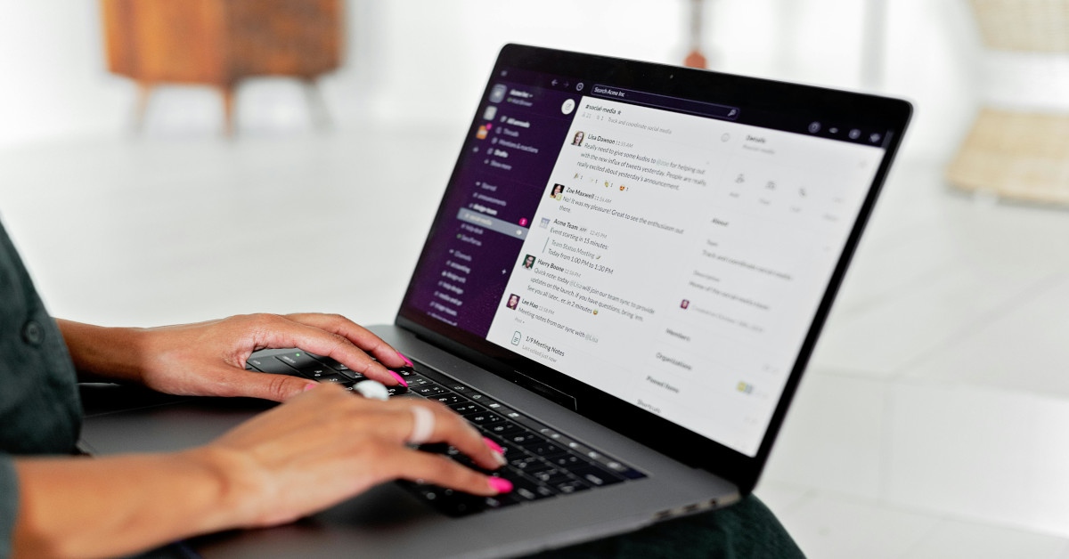 A woman moderating a chat on her laptop.