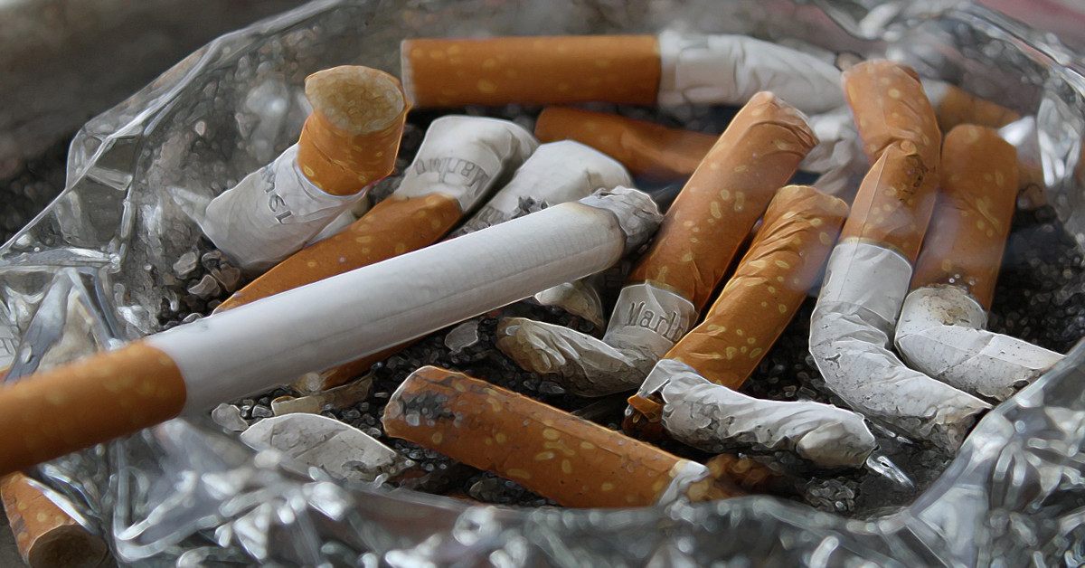 A lot of cigarettes in an ashtray indicates a cigarette addiction.