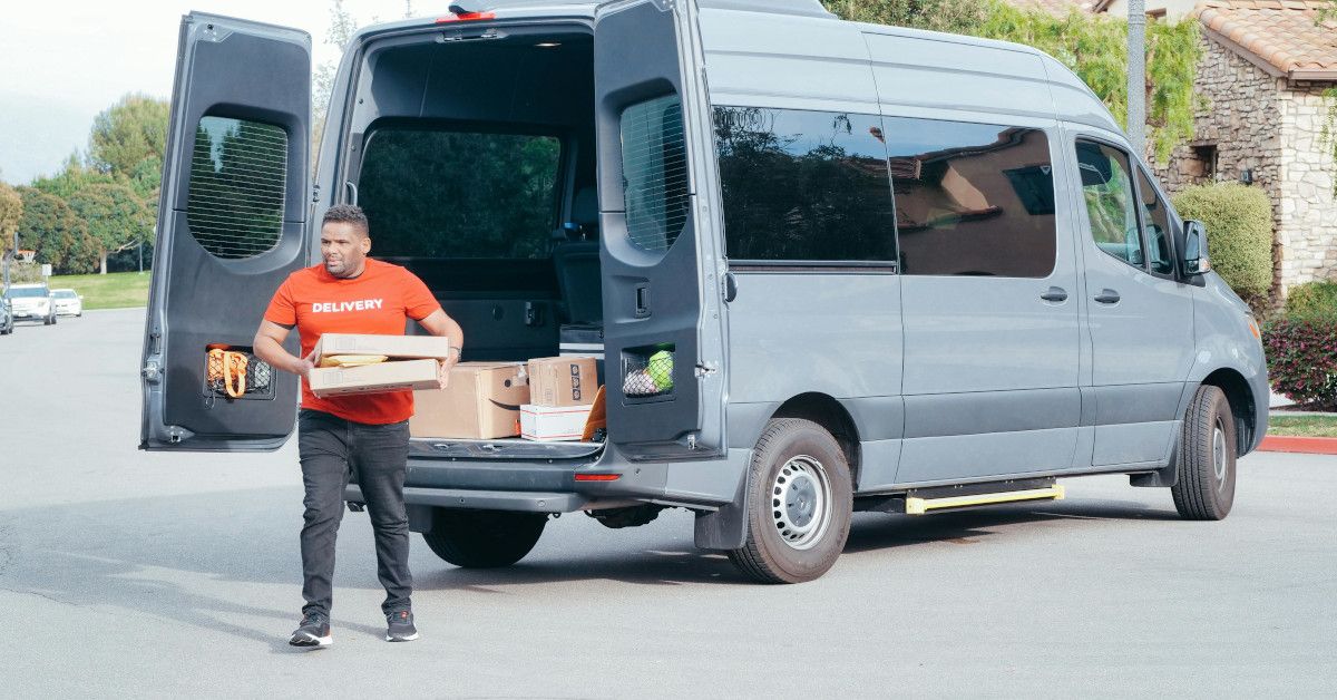 A delivery man delivering packages with his car.