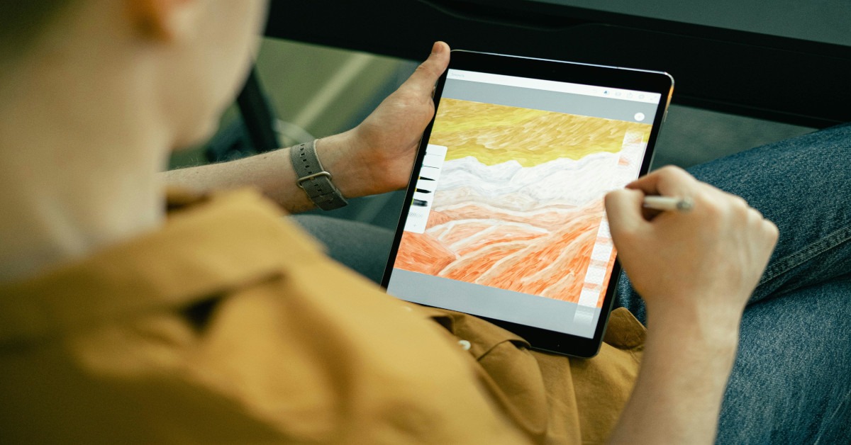 A man drawing on a tablet.