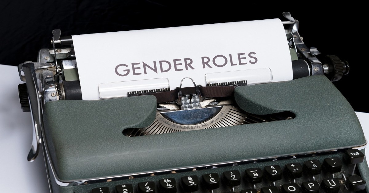 A typewriter with the words "gender roles" typed on a paper.