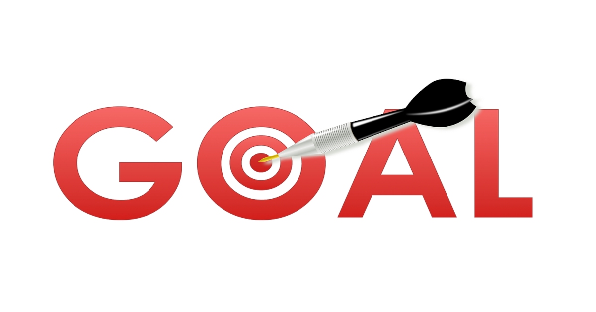 Illustration of the word "goal" written in red letters with the letter "o" being a bullseye with a black dart in the middle of it.