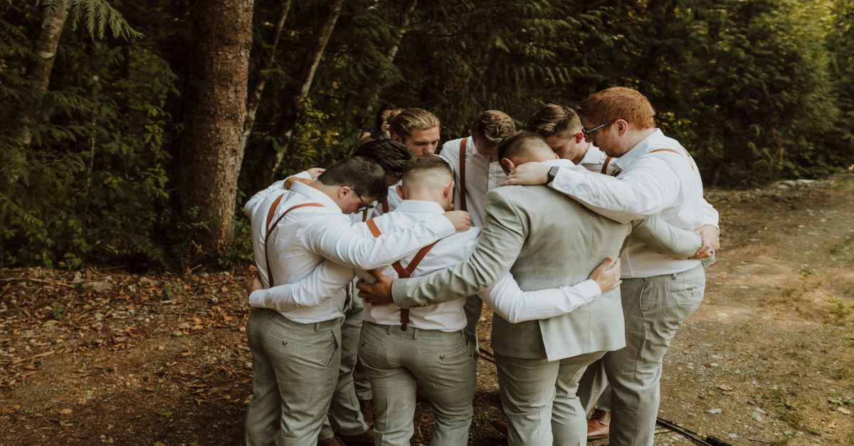 A group of friends in costume hugging.