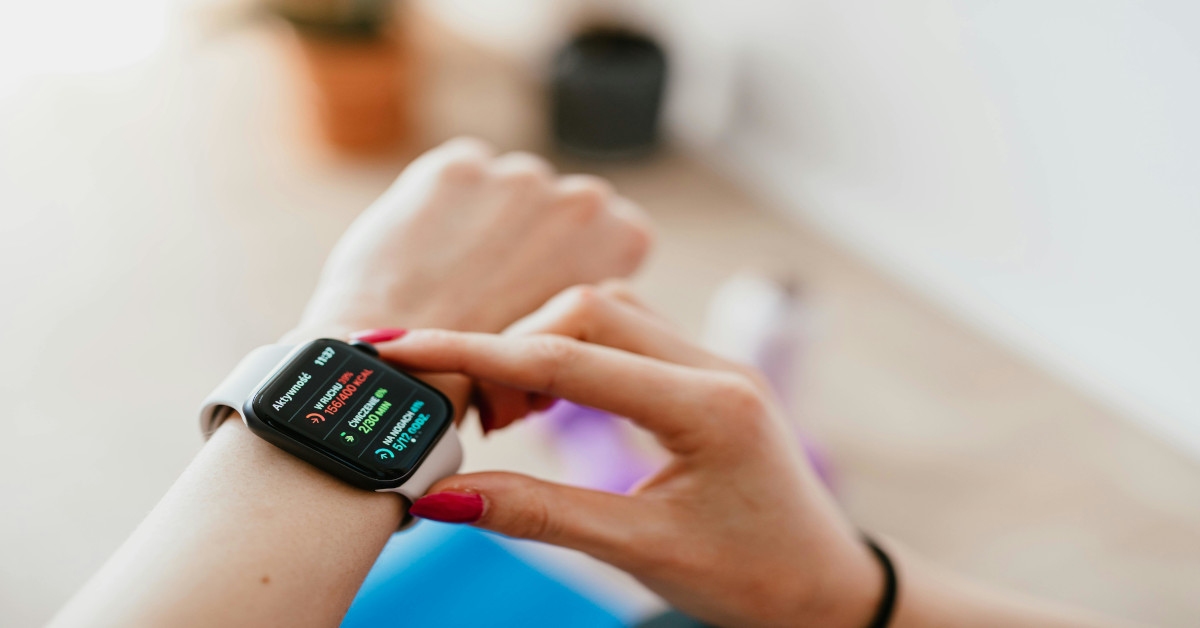 A person checking their heart rate monitor on their watch.