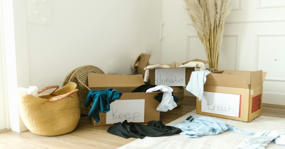 Three boxes with clothes reading "keep", "donate", and "trash".