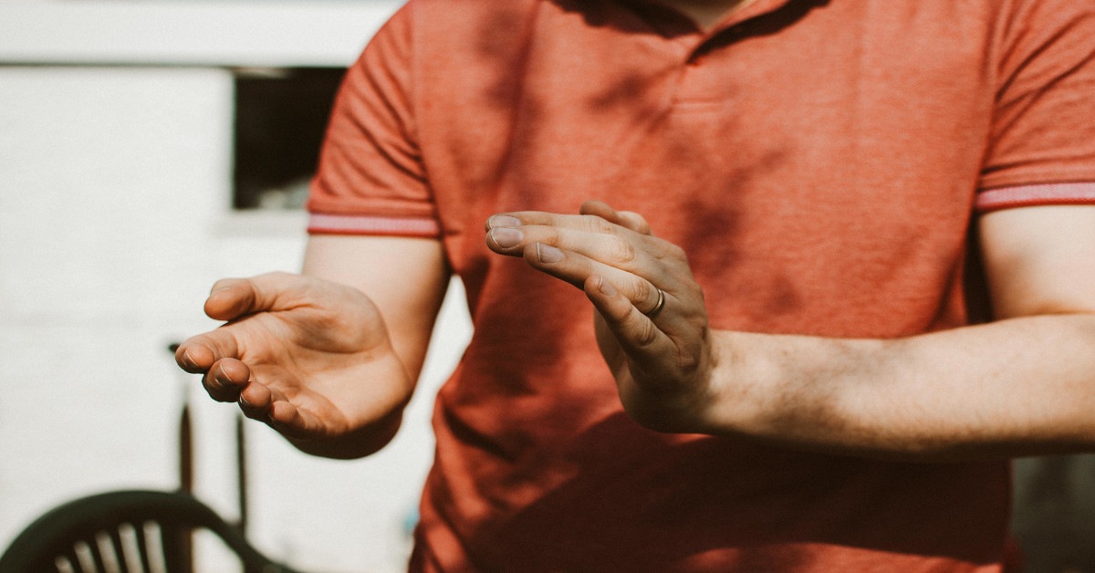 A man clapping his hands together.
