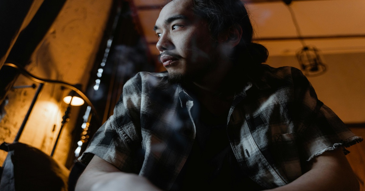 A man ruminating while sitting.