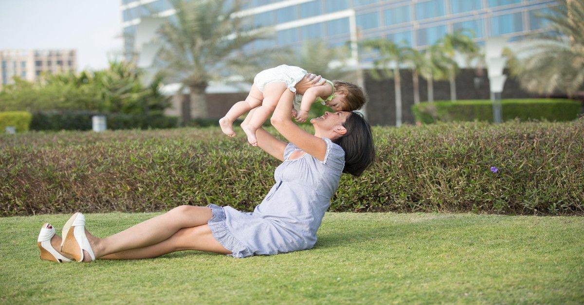 A mother and daughter playing outside.