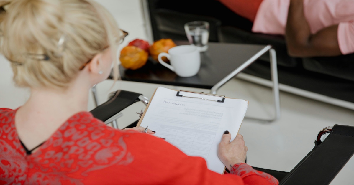 An occupational therapist asking questions to a patient.
