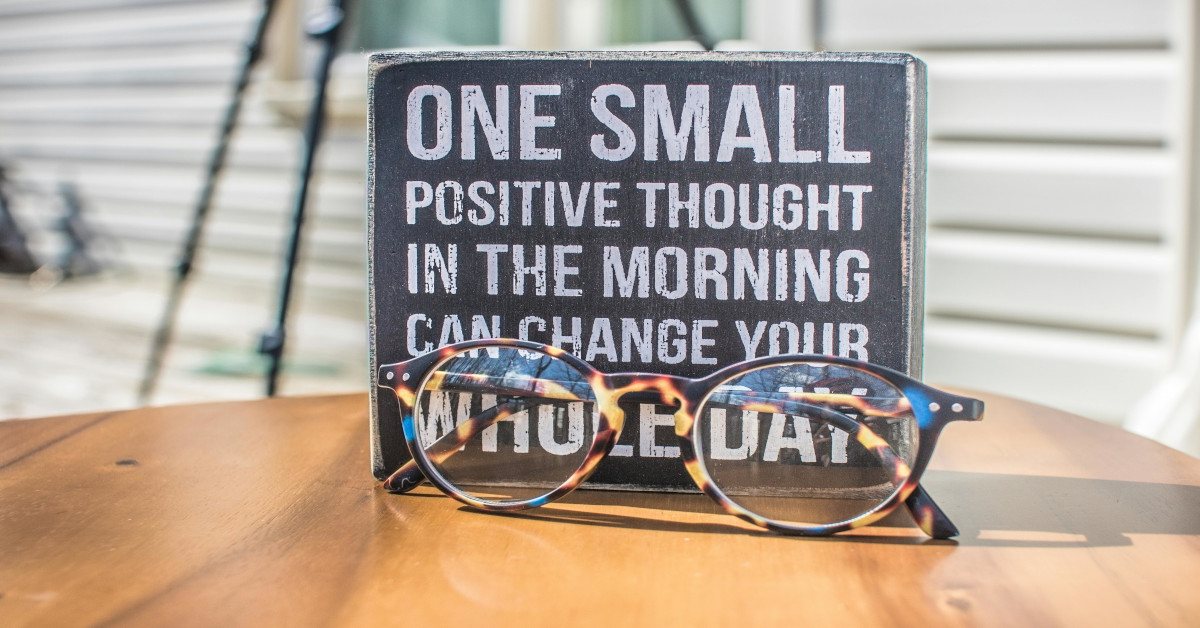 The quote, "one small positive thought in the morning can change your whole day," was written on a note resting on top of a table.
