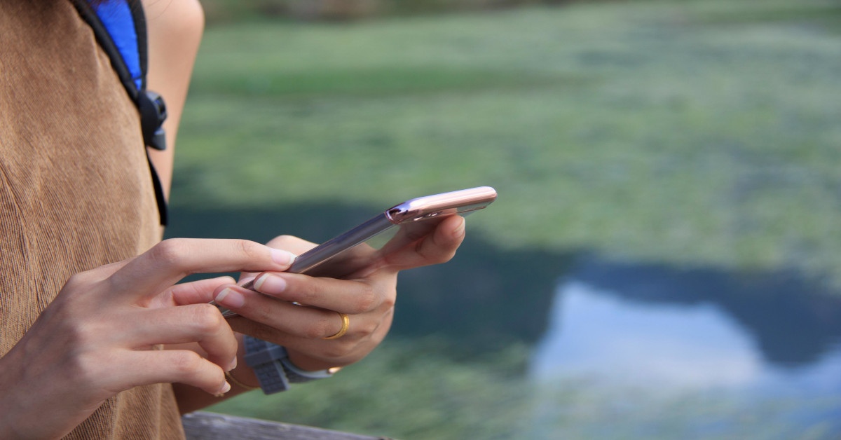 A person using a smartphone outside.