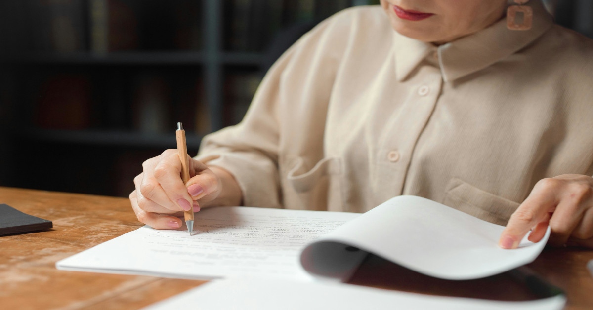 A woman proofreading and editing a script.