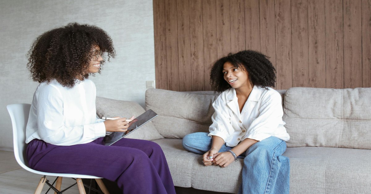 Psychologist and client laughing.