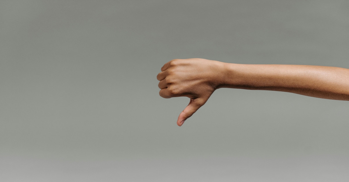 A person performing the thumbs down sign.