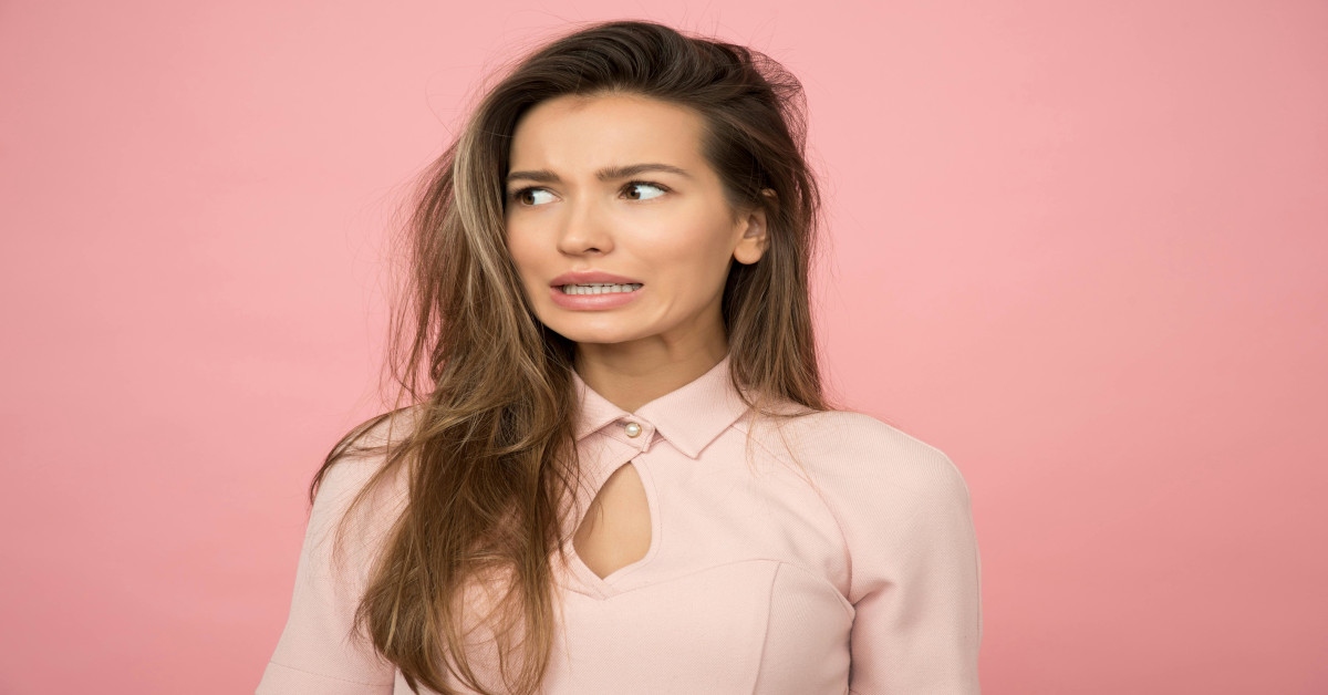 Image of a woman making an uncertain face.