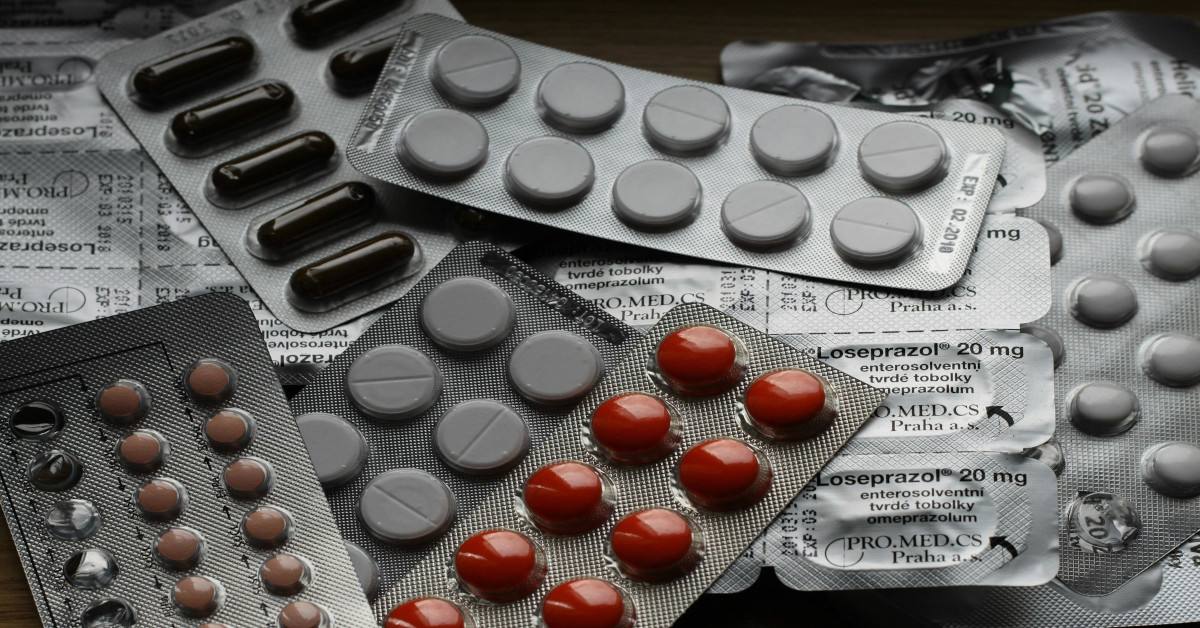 Various medication strips lying on a table.