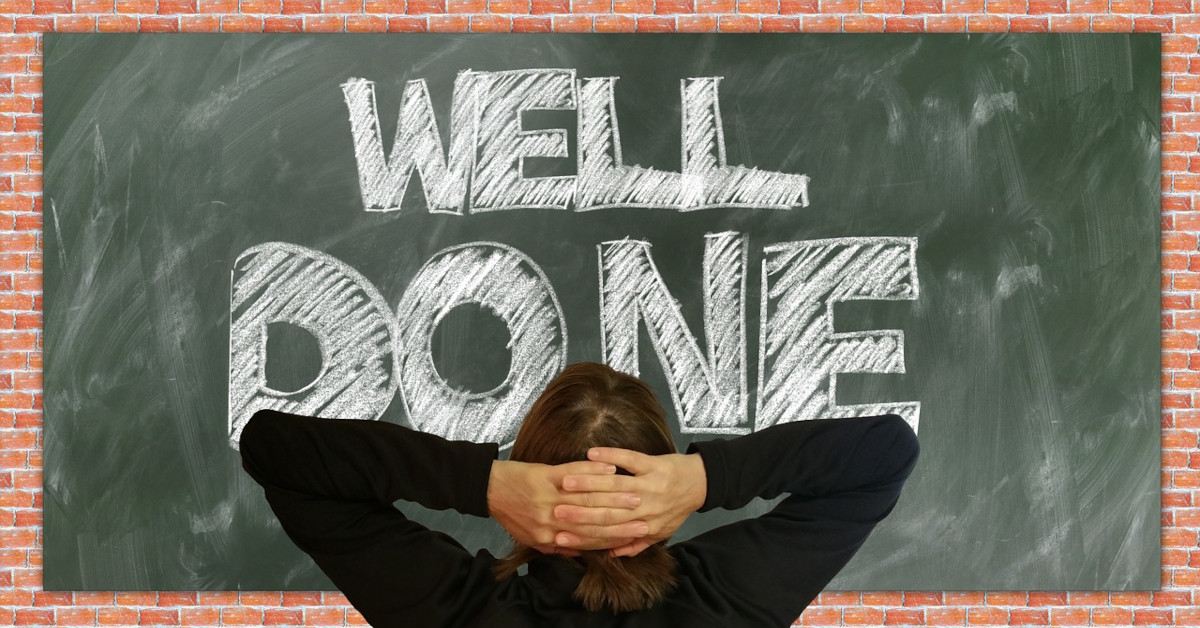 Someone looking at a blackboard saying "well done".