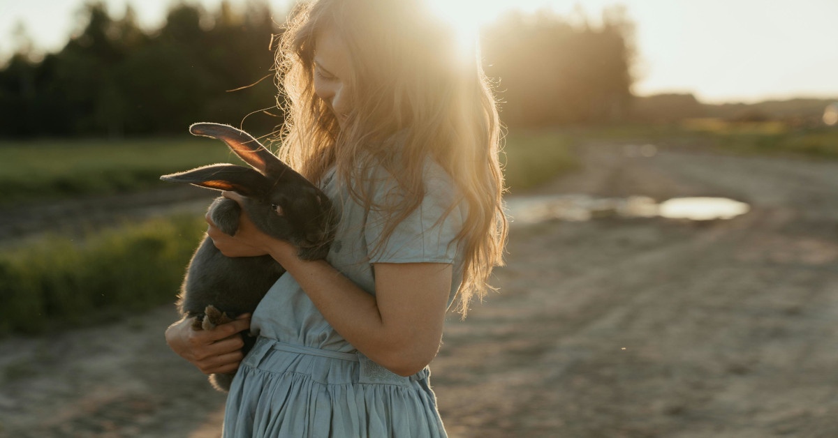 Image of a young woman holding a bunny.