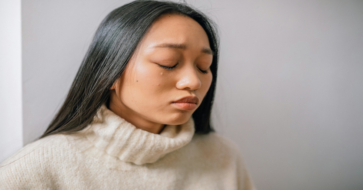 A woman who's crying and looking sad.
