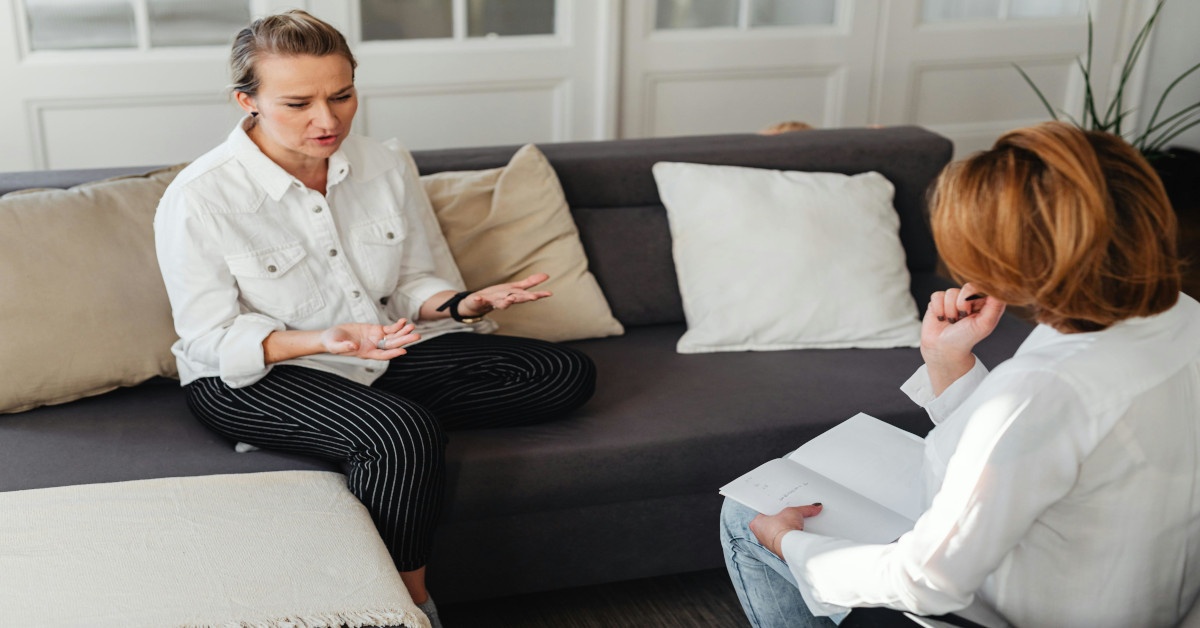 A therapist listening to a client explaining her problems.