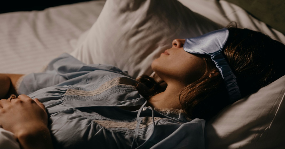 A woman is asleep while wearing an eye mask.