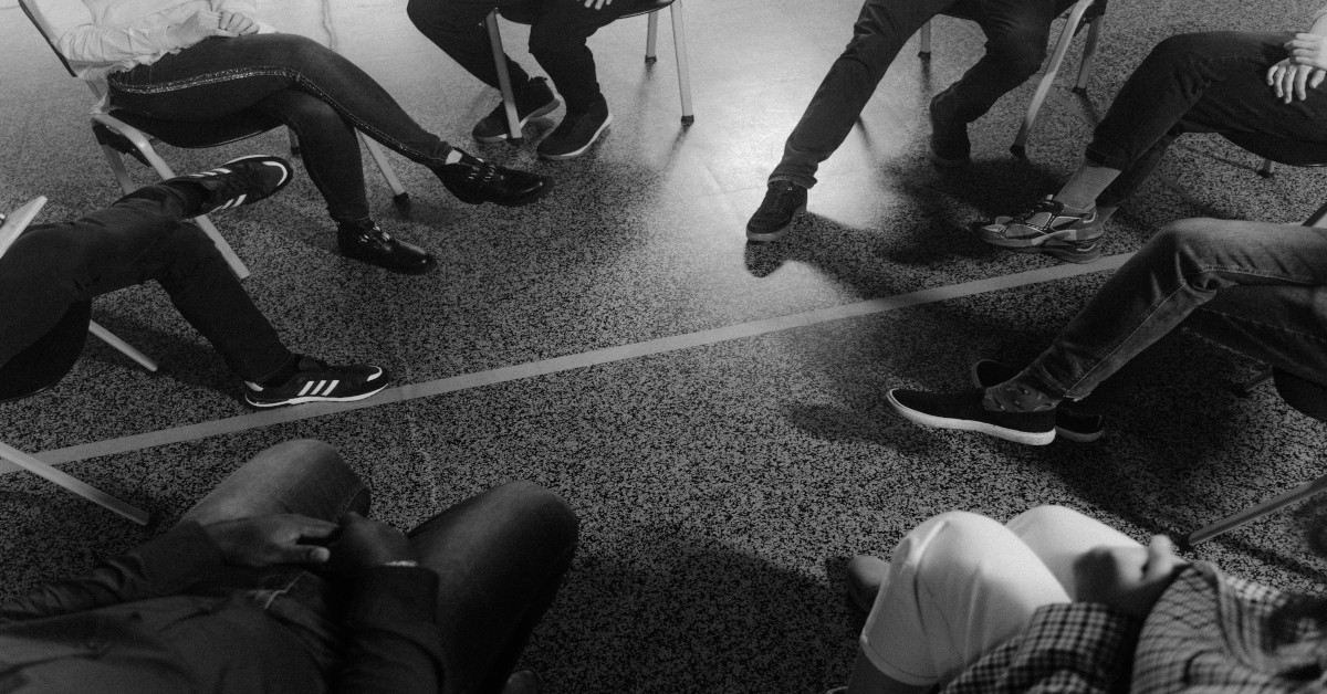 A black and white image of a support group.