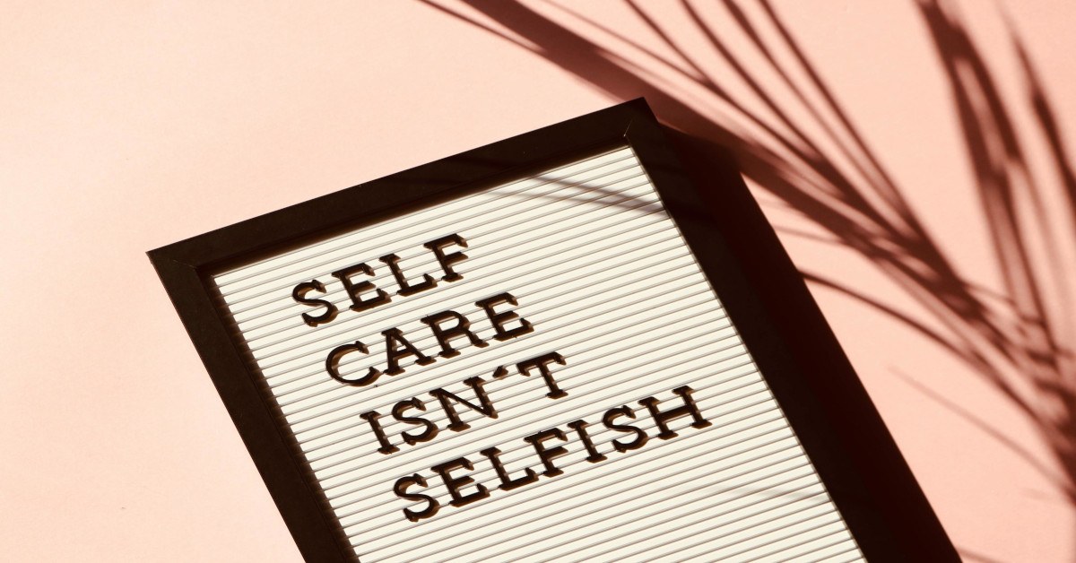A blackboard reading "self-care isn't selfish".