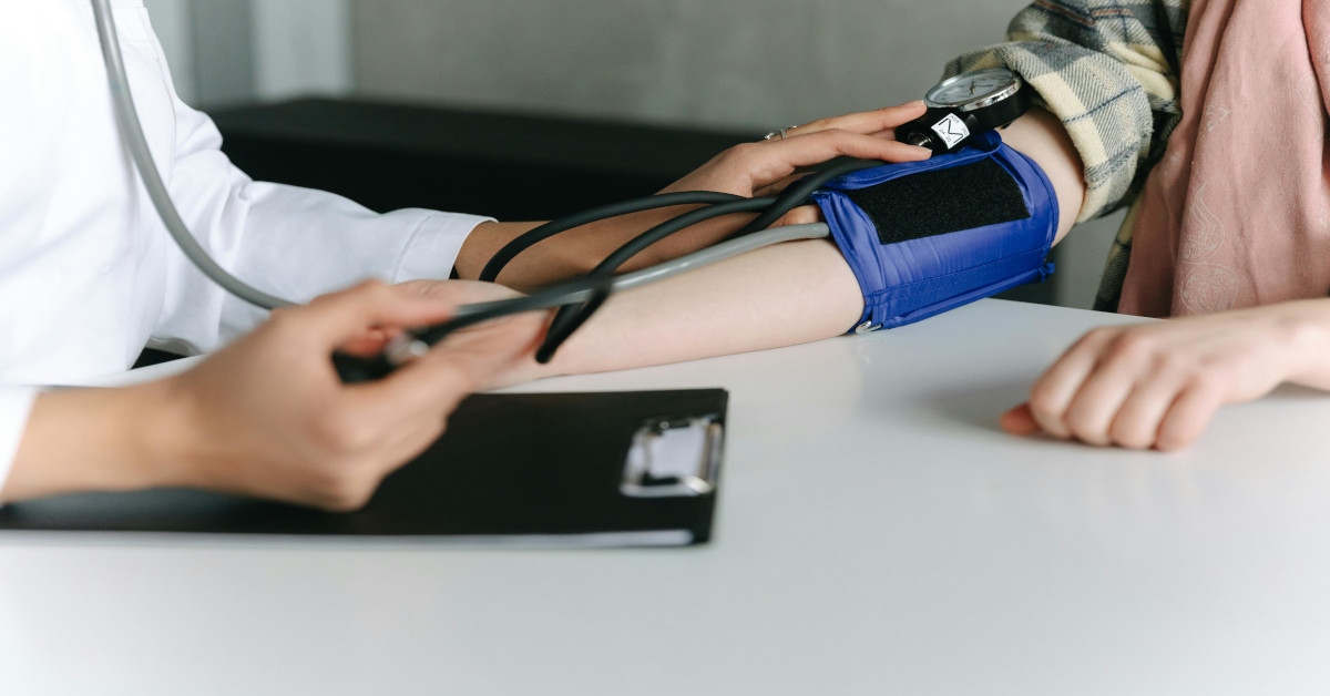 A doctor taking a patient's blood pressure.